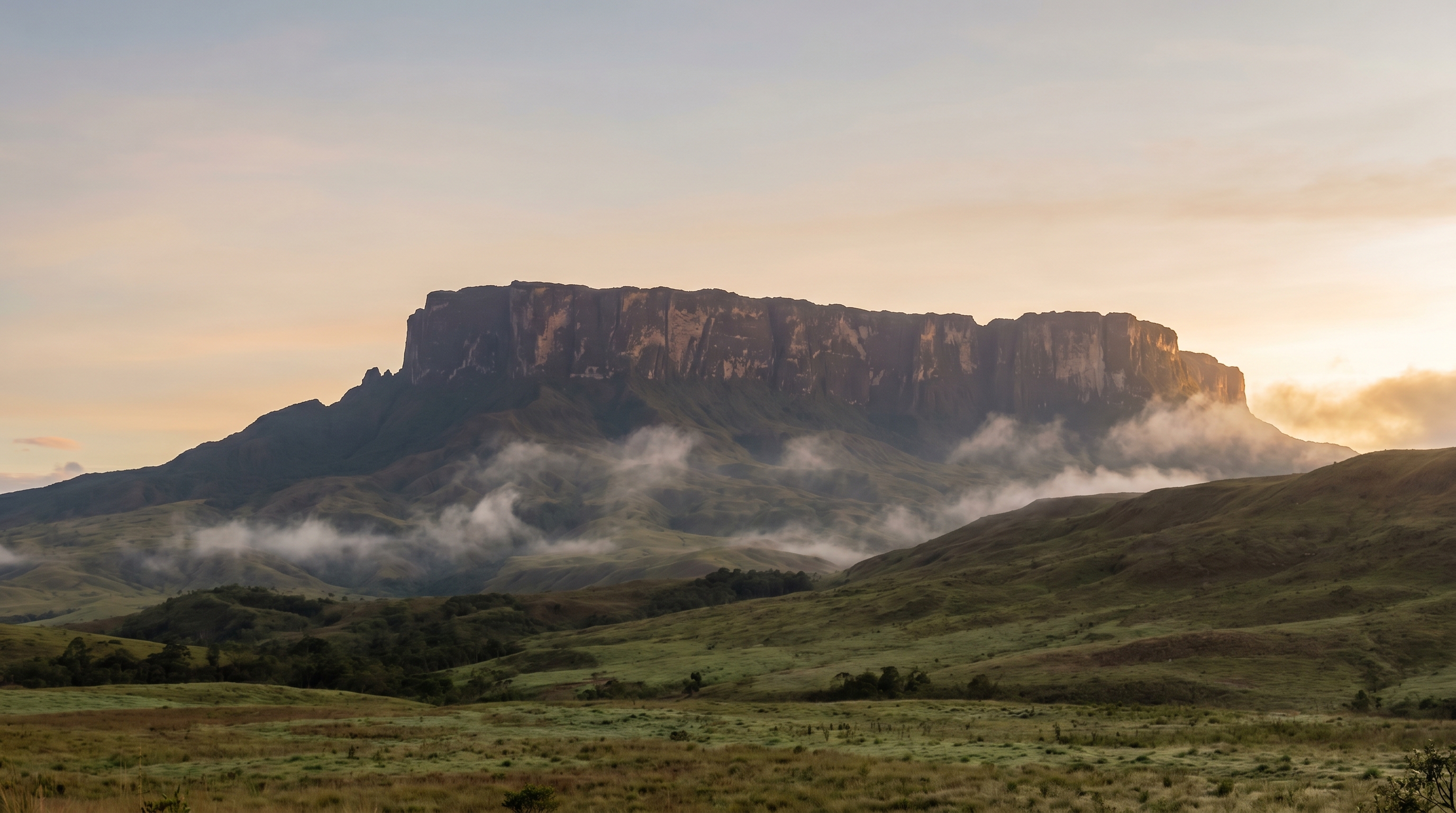 Wide-angle photographic view of the flat-topped Mount Roraima tepui at dawn with mist rising from the savannah below, no logos, no signage, no people