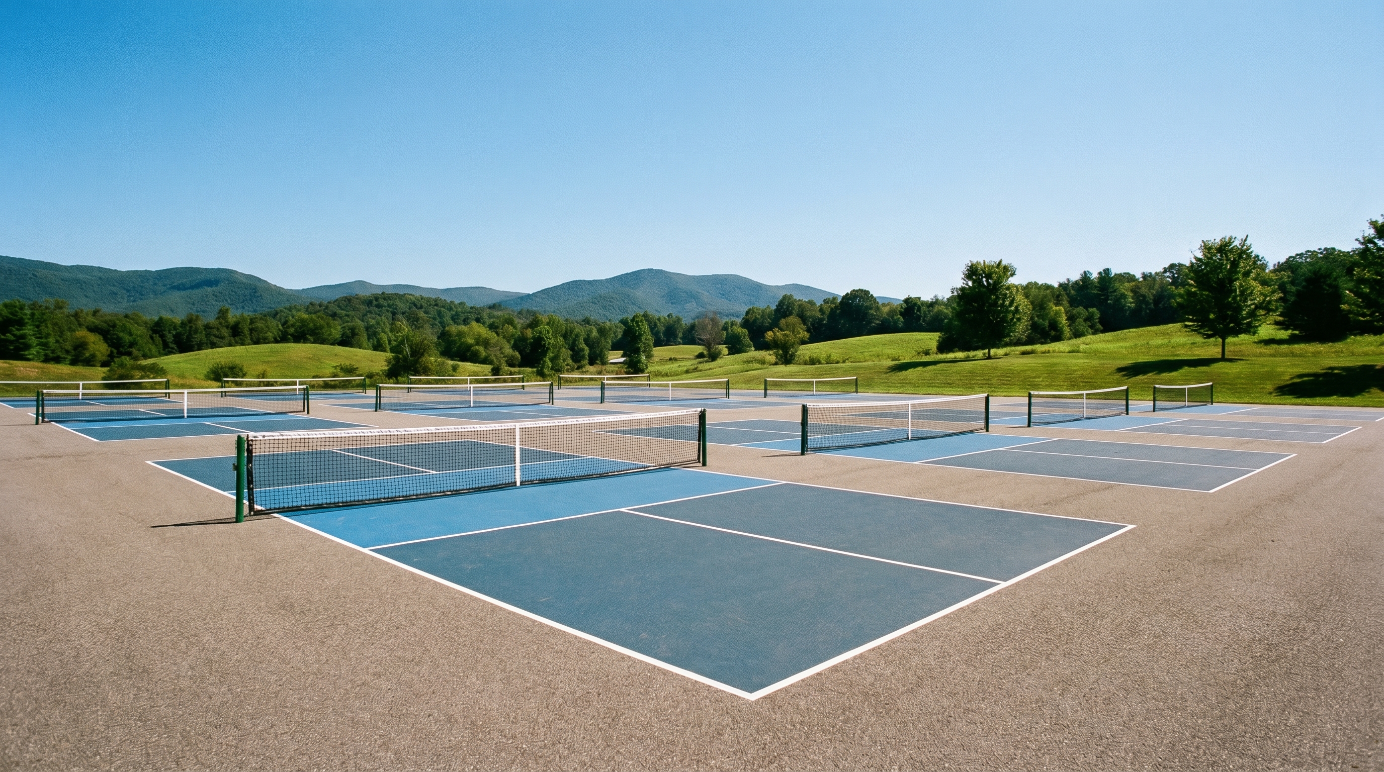 Outdoor pickleball courts with nets on a sunny day